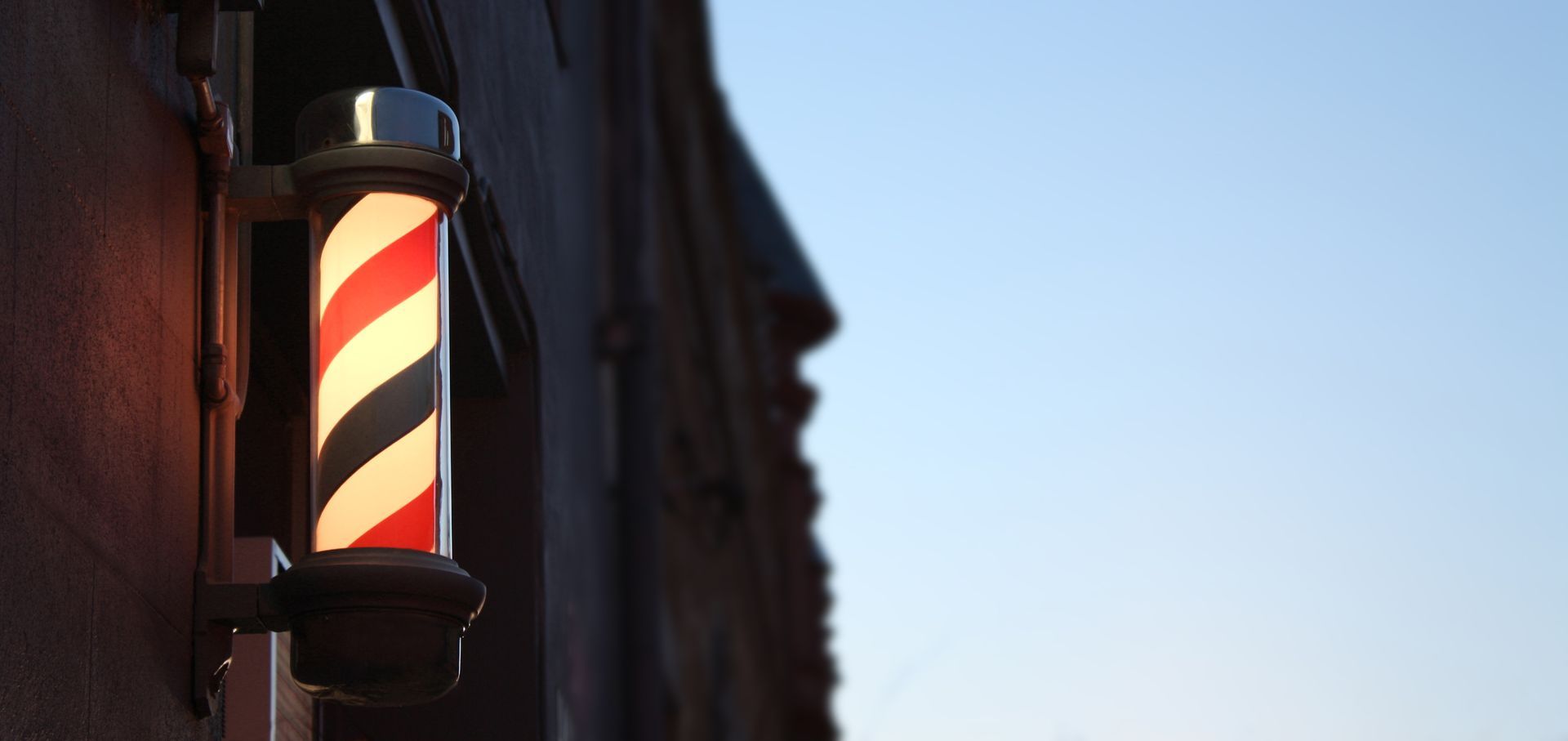 Barbershop counter with tools; brick wall background.