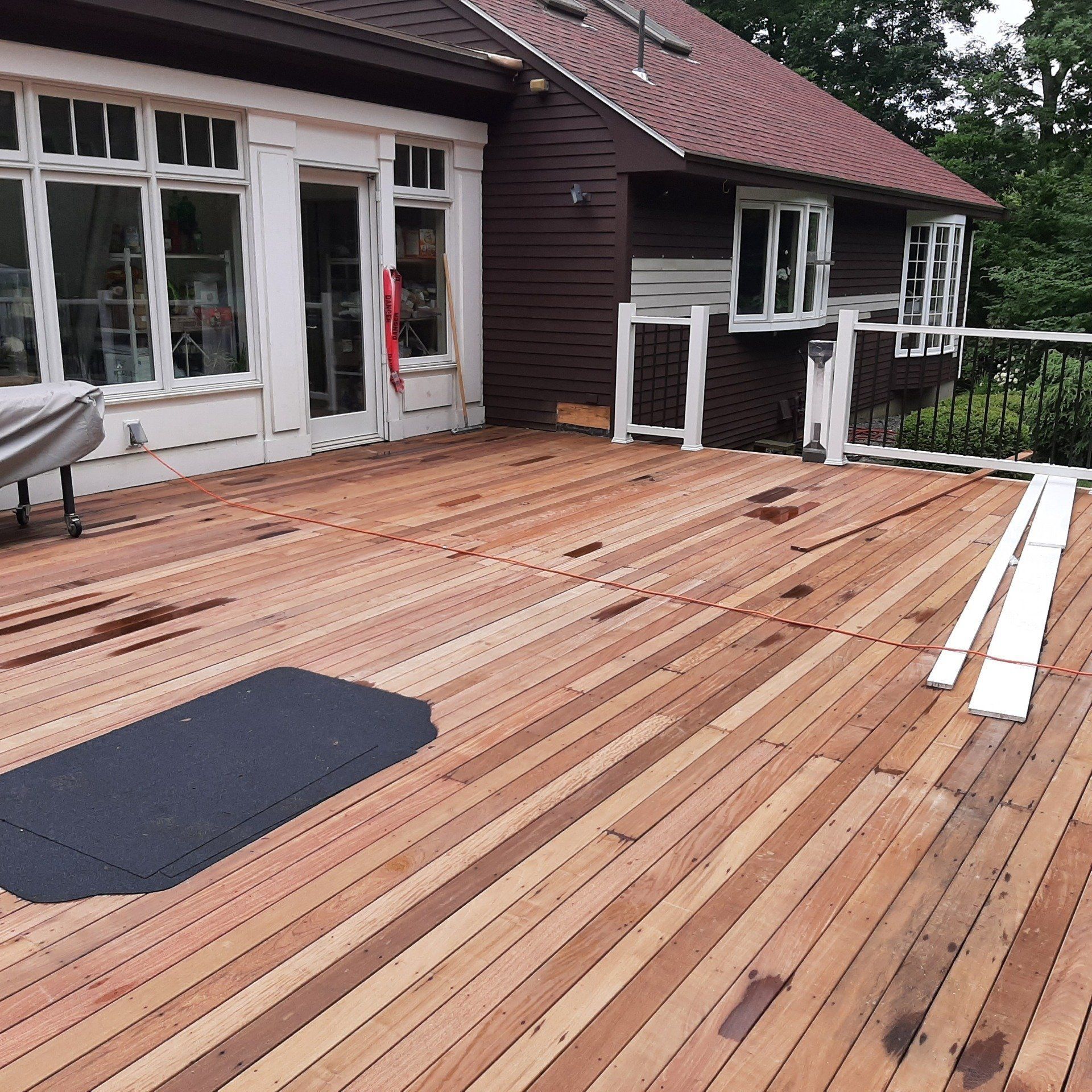 A large wooden deck in front of a house - Plaistow, NH - Dynamic Deck Solutions