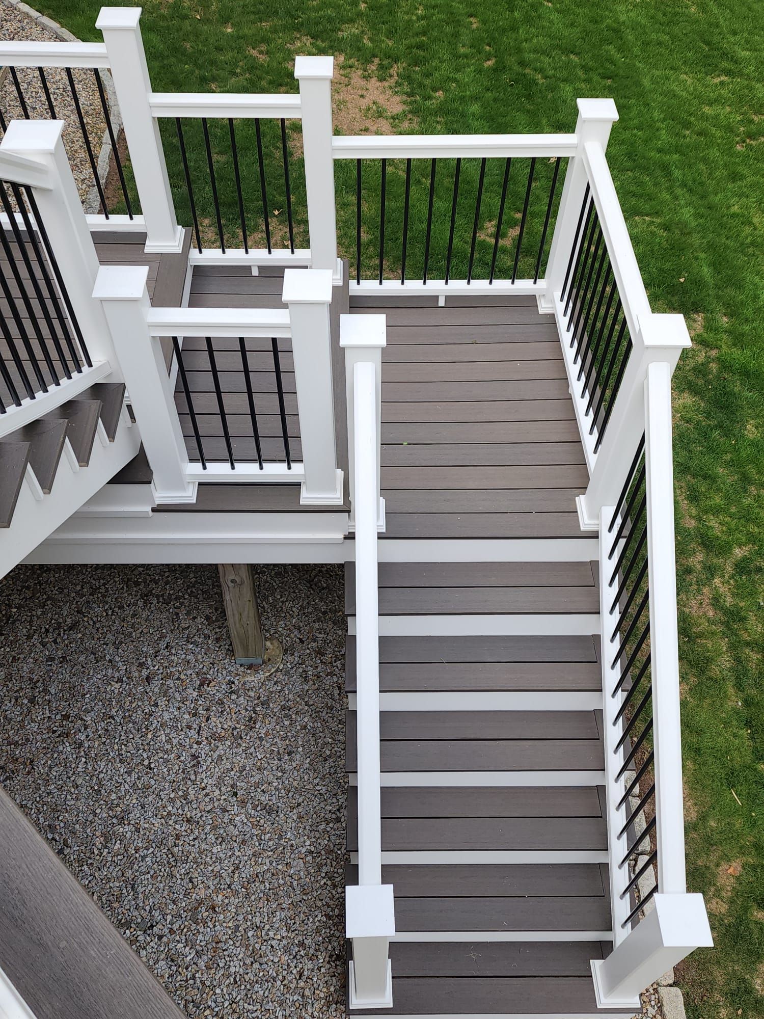 An aerial view of a deck with stairs and a white railing.