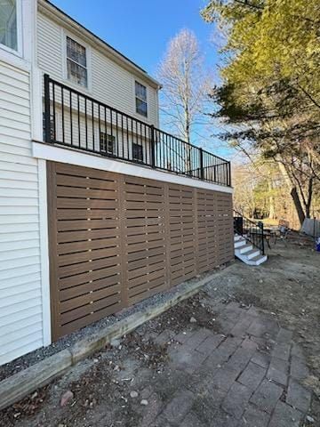 A house with a deck and stairs on the side of it - Plaistow, NH - Dynamic Deck Solutions