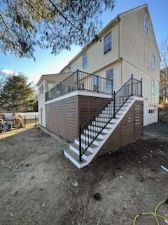 A house with a deck and stairs leading up to it - Plaistow, NH - Dynamic Deck Solutions