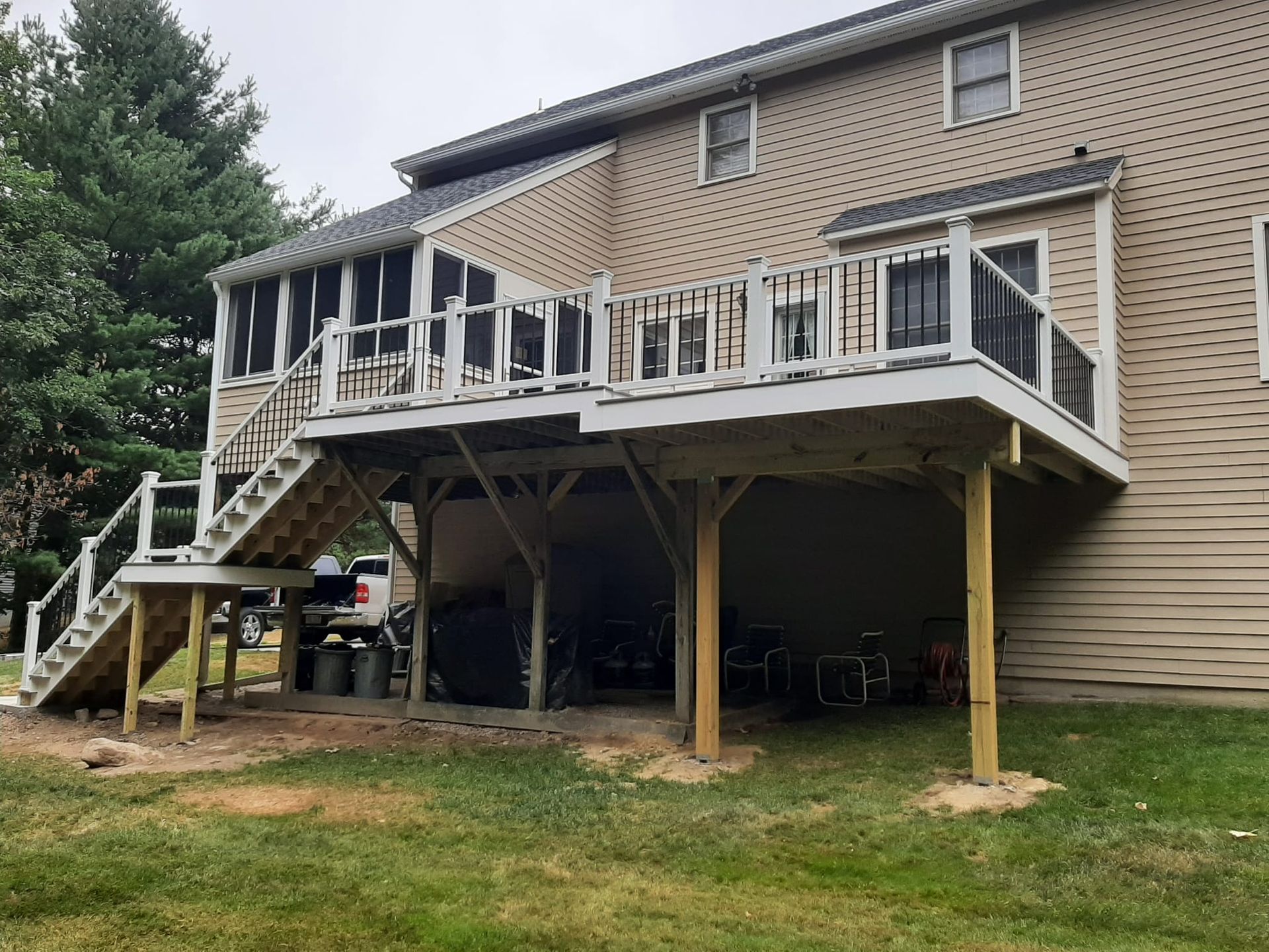 The back of a house with a large deck and stairs - Plaistow, NH - Dynamic Deck Solutions