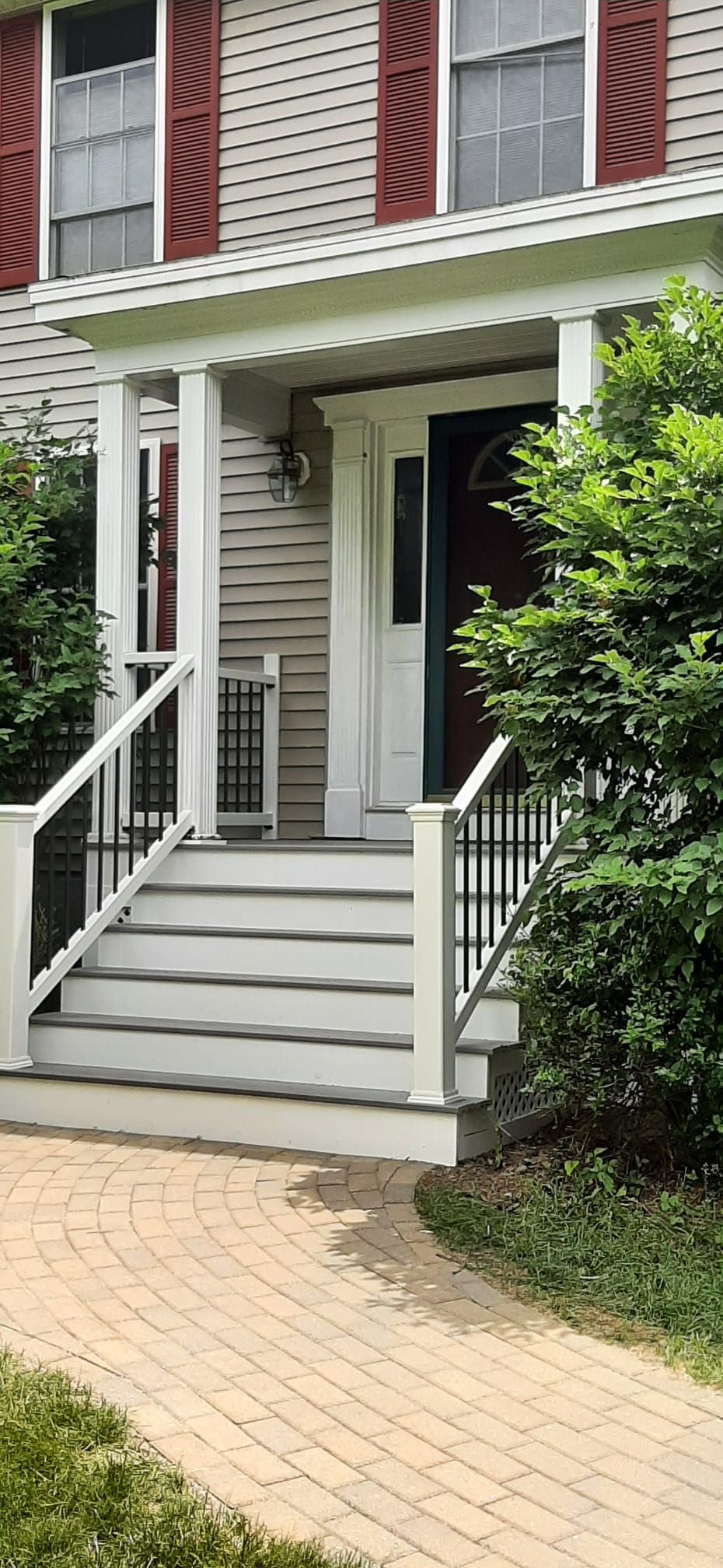 The front porch of a house with stairs leading up to it - Plaistow, NH - Dynamic Deck Solutions