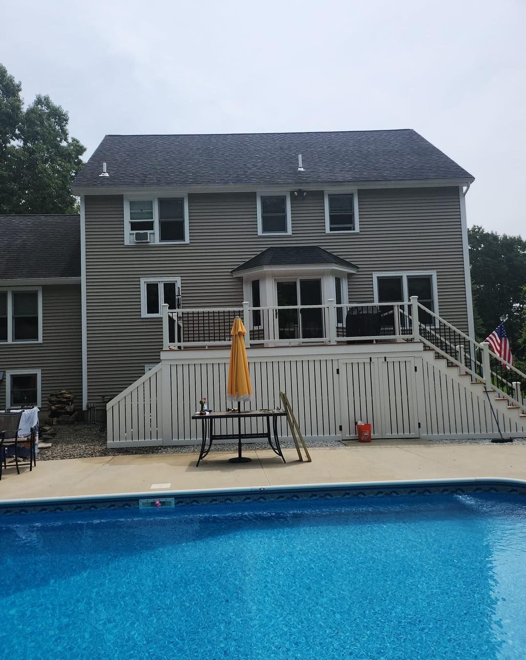 A large house with a swimming pool in front of it - Plaistow, NH - Dynamic Deck Solutions