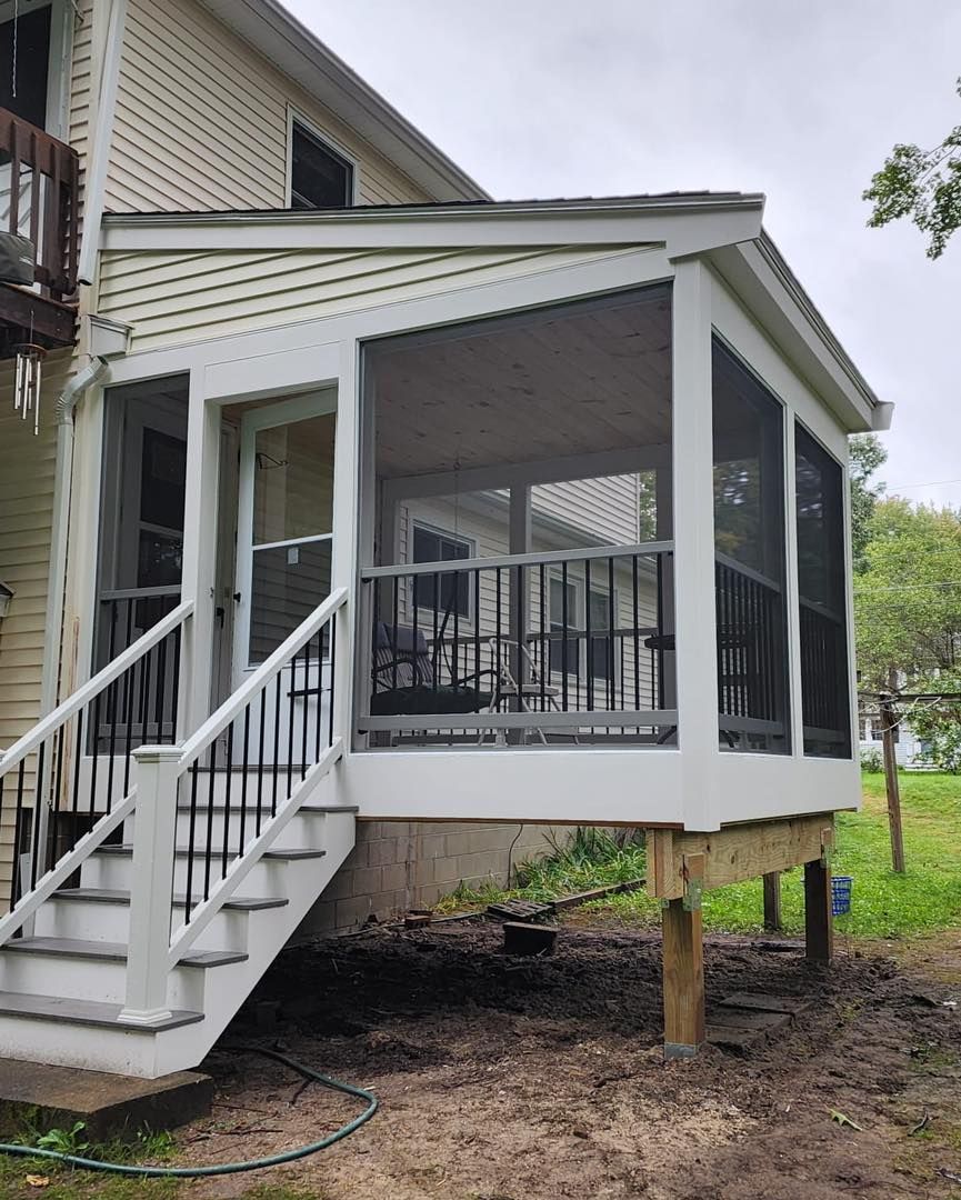 A screened in porch with stairs leading up to it - Plaistow, NH - Dynamic Deck Solutions