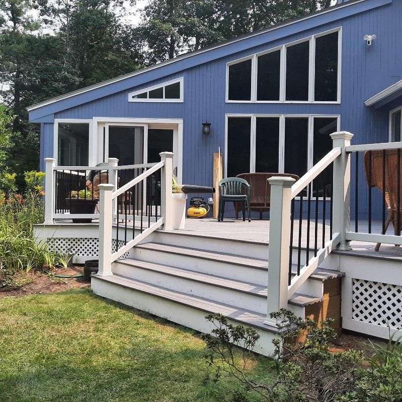 A blue house with a white deck and stairs - Plaistow, NH - Dynamic Deck Solutions