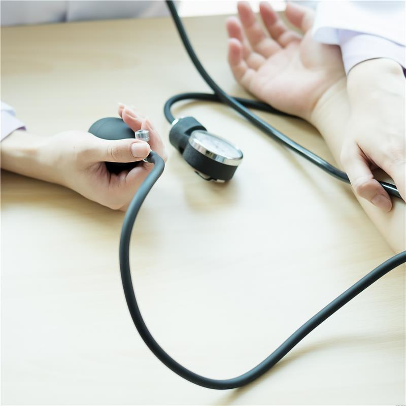 Concierge medicine doctor in Maryland checking patient’s blood pressure during a primary care visit