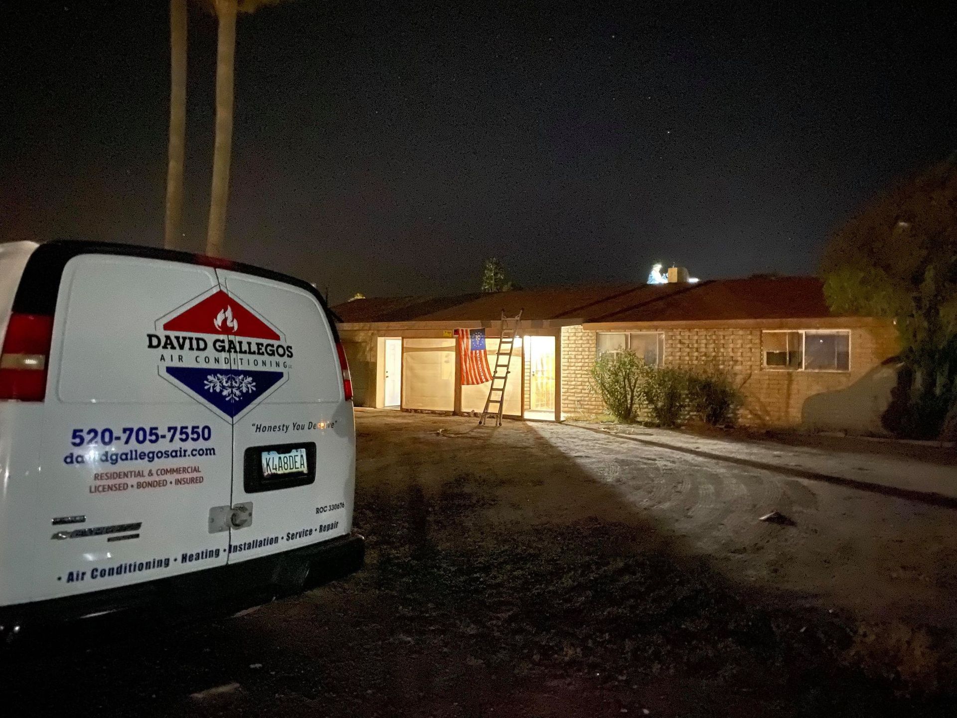 a white van is parked in front of a house at night .