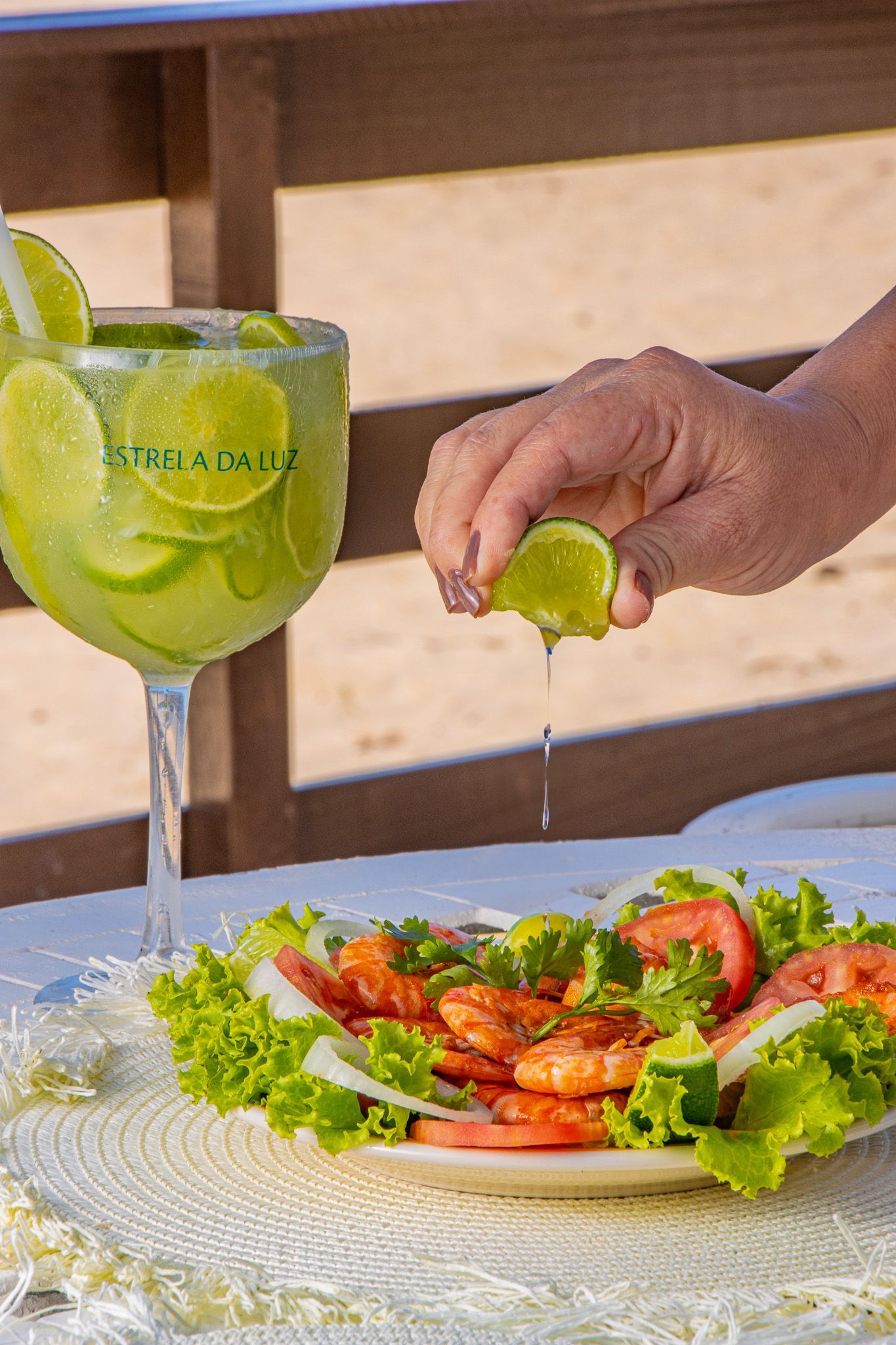 A person is squeezing a lime over a plate of food.