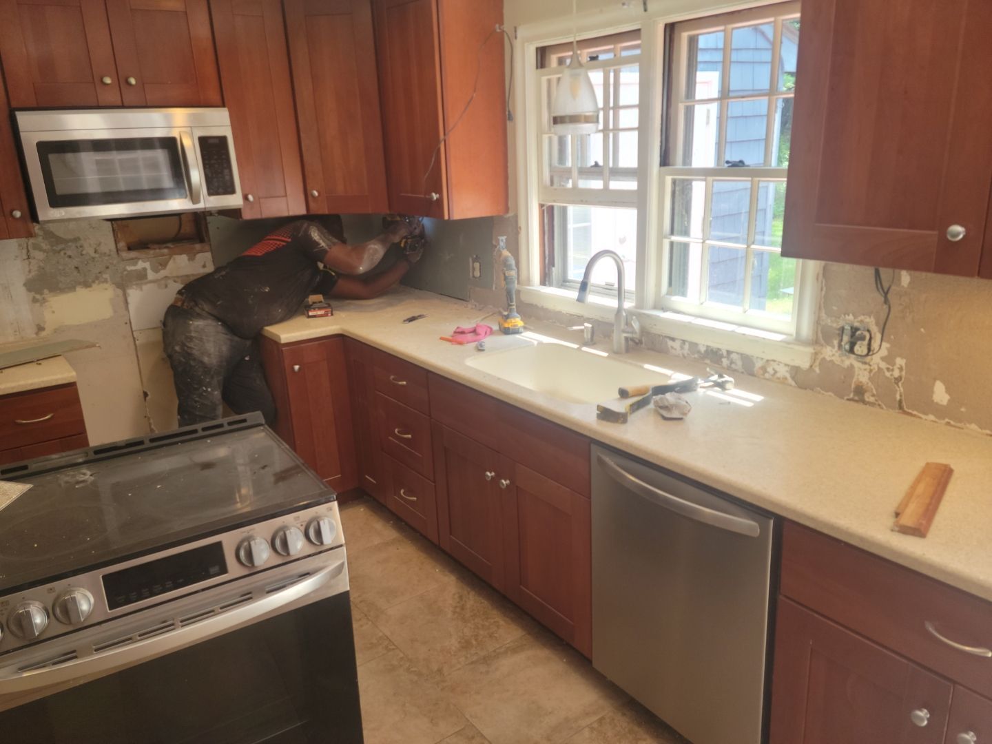 A repairman is working in the kitchen – Hartford, CT - Hinds