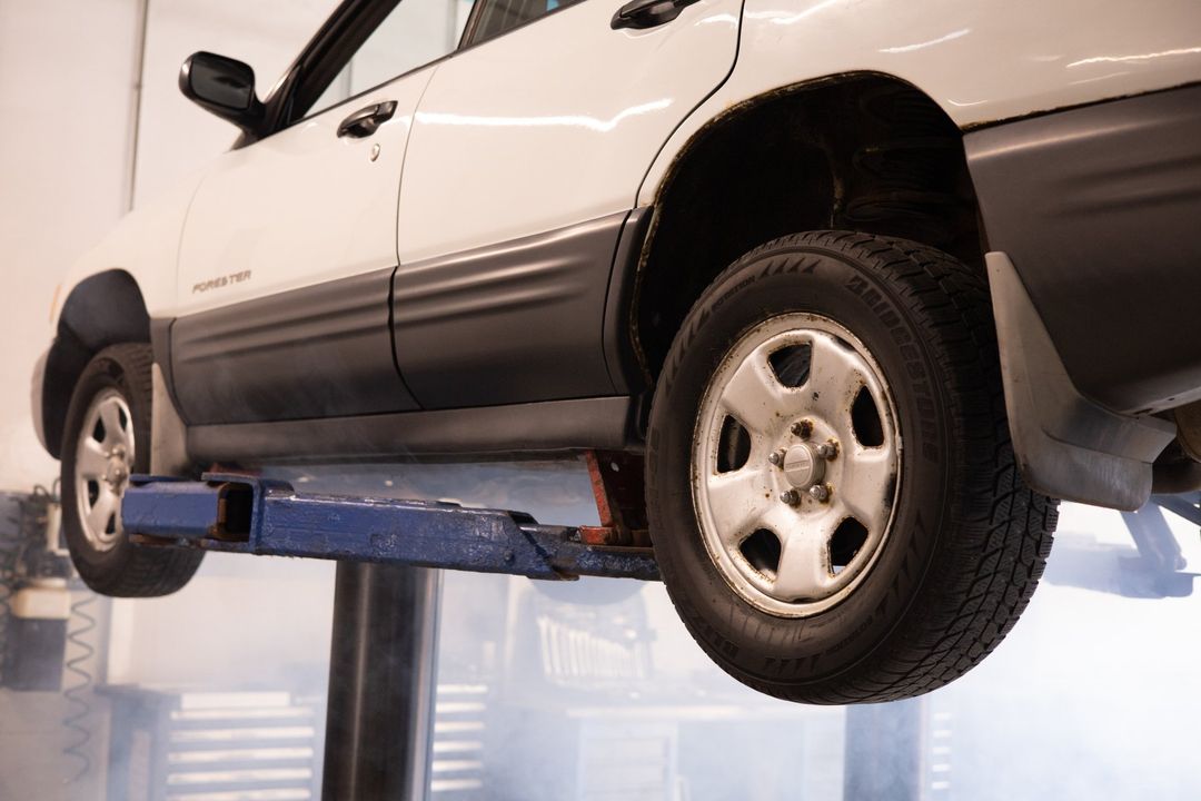 New tires being installed on a white car