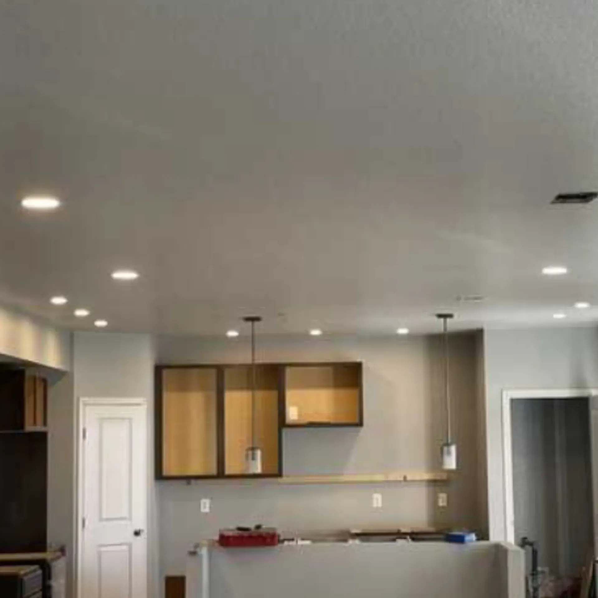 Grounded Electric - A kitchen with a ceiling that is very high and a lot of cabinets.