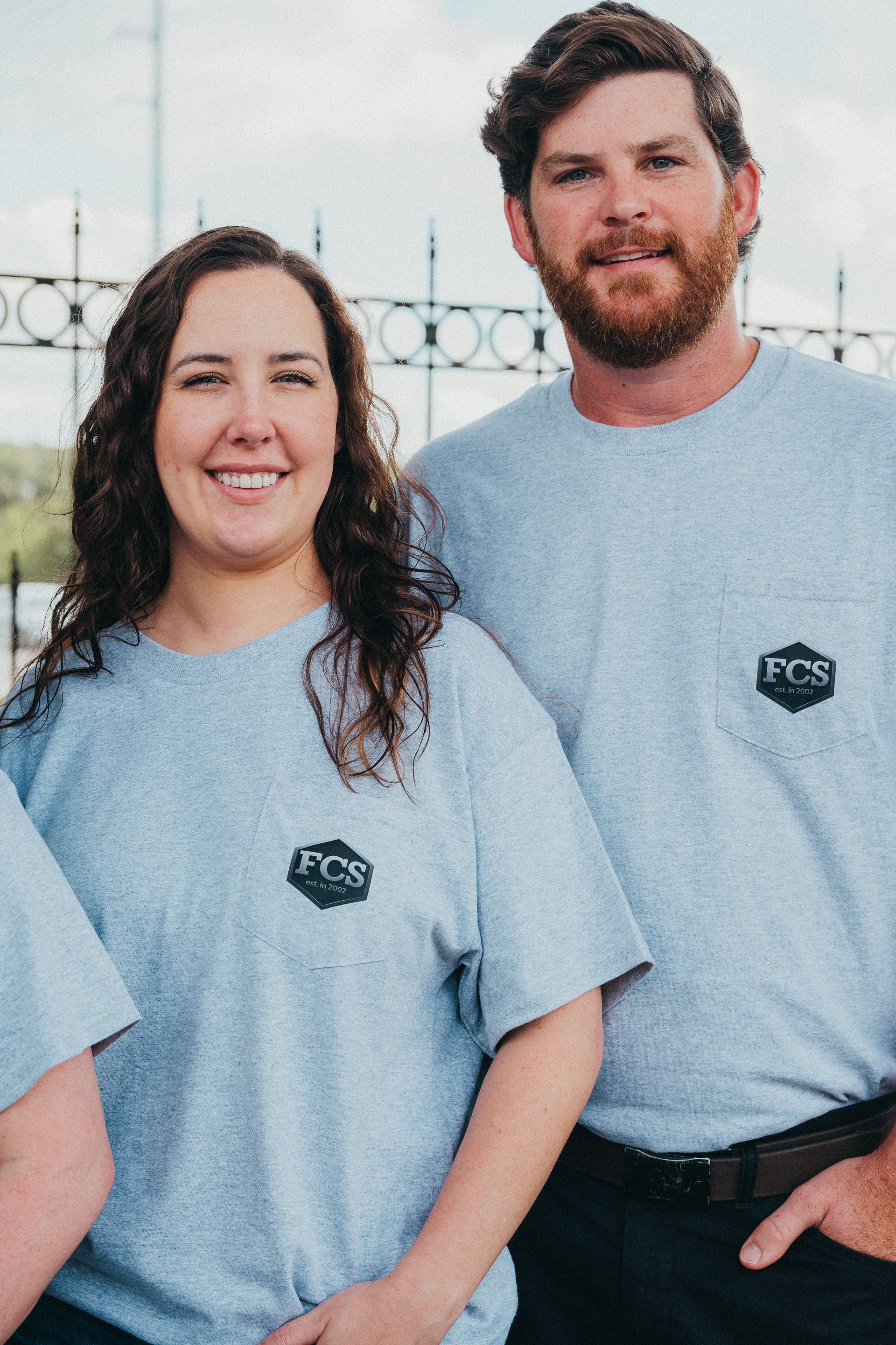 A group of construction workers are sitting around a table looking at blueprints.