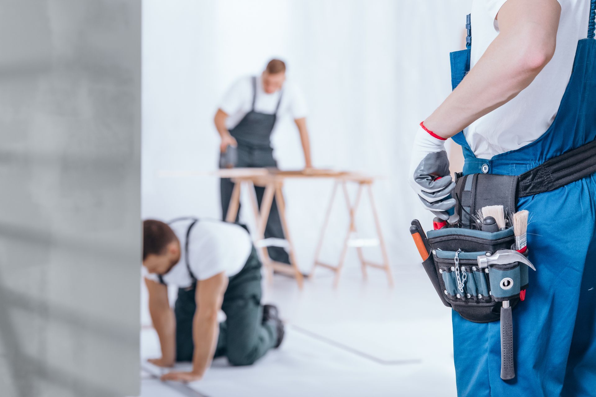 A man is standing in front of a group of construction workers.