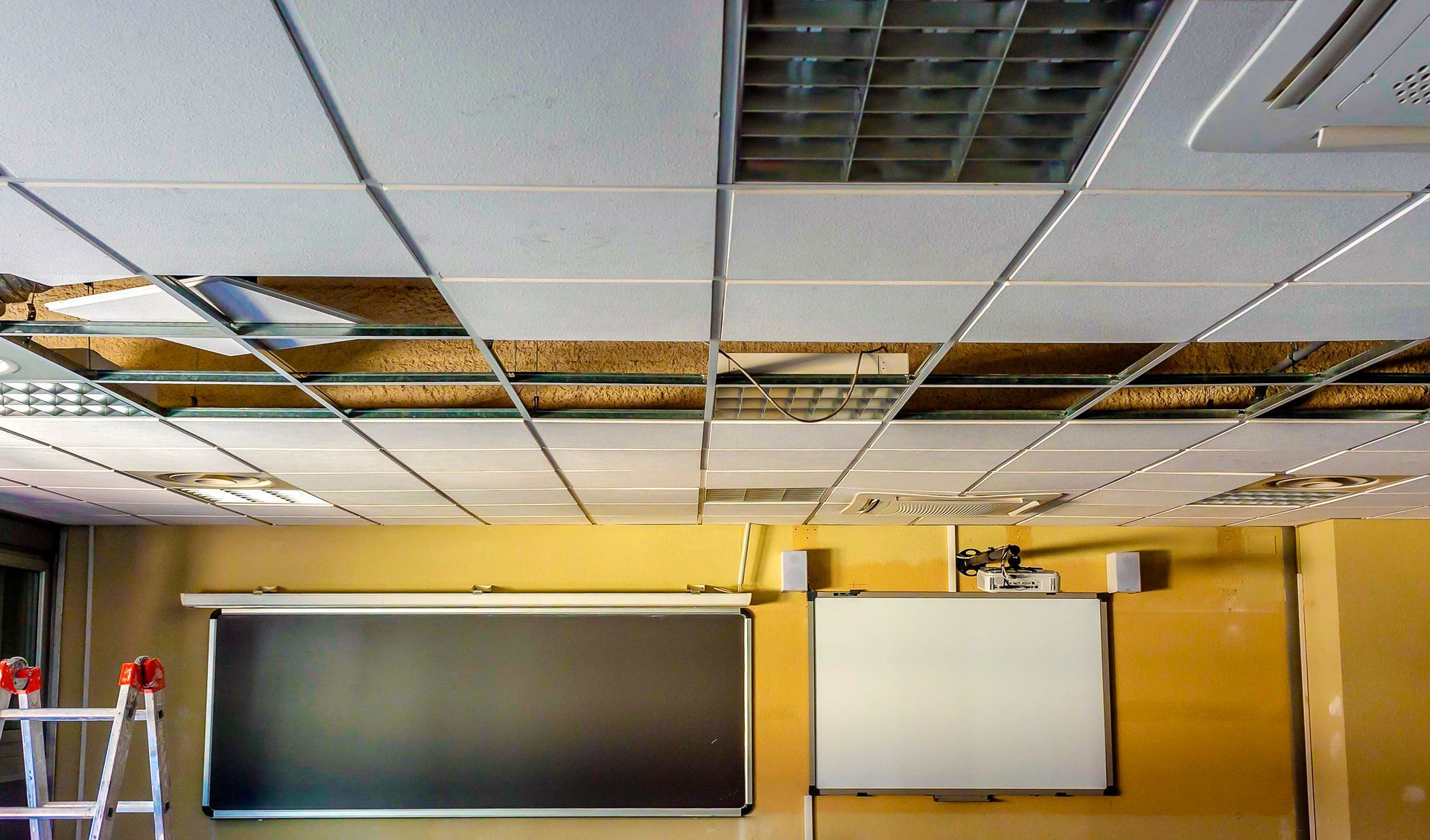 A construction worker is holding a blue hard hat on a construction site.