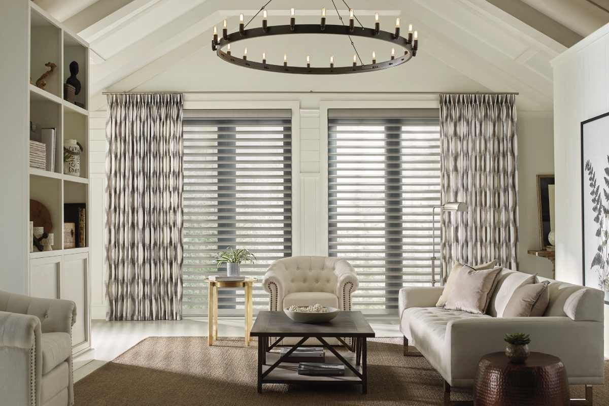 Window shutters installed in a home, flanked on either side by flowing drapes near Glendora, California (CA)