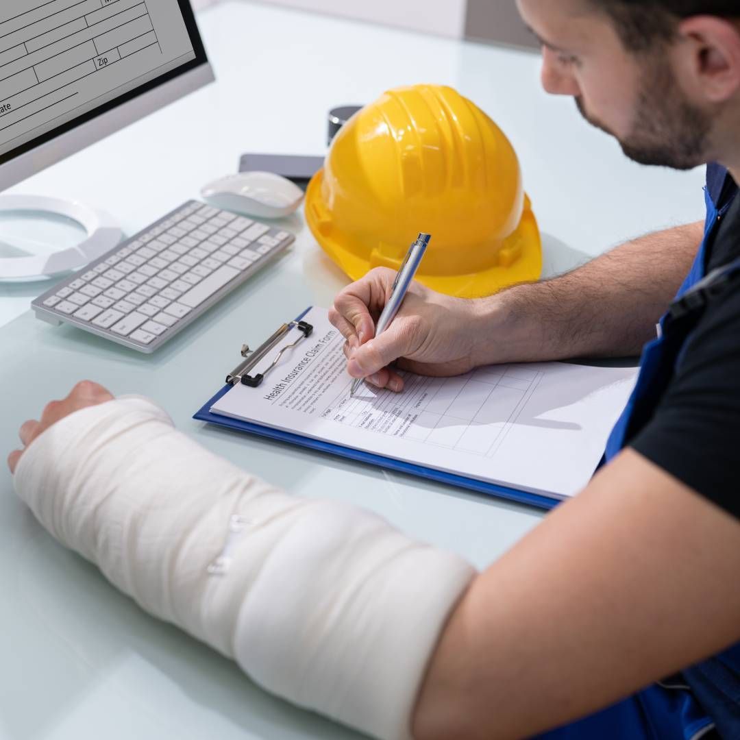 A man with a cast on his arm is writing on a clipboard