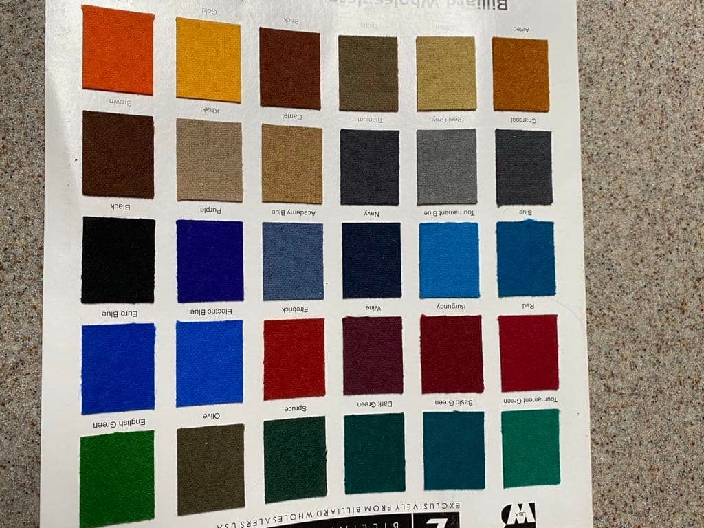 Color swatches in various shades displayed on a white sheet, presumably for material selection.