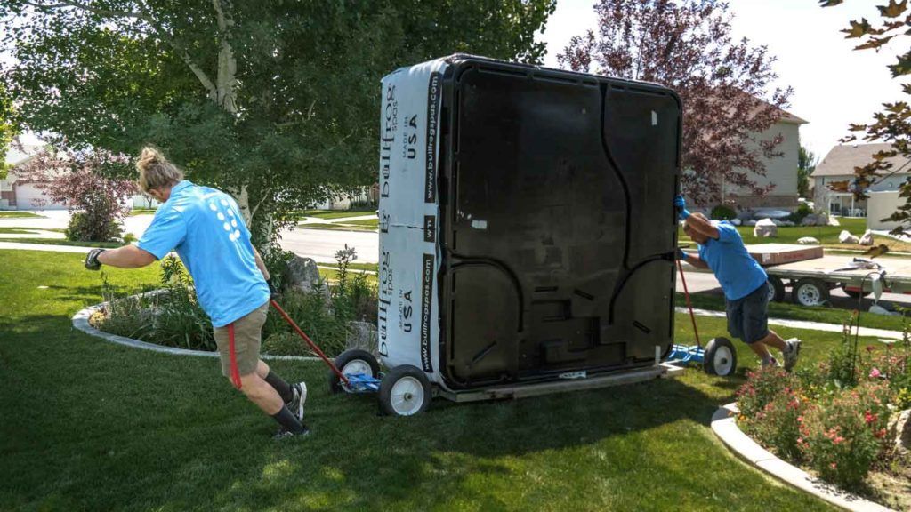 Pool table with a cue stick and several billiard balls.