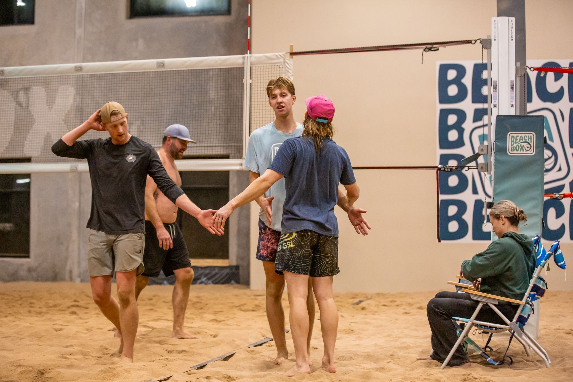 People playing volleyball on a sand court. People playing volleyball on a sand court.