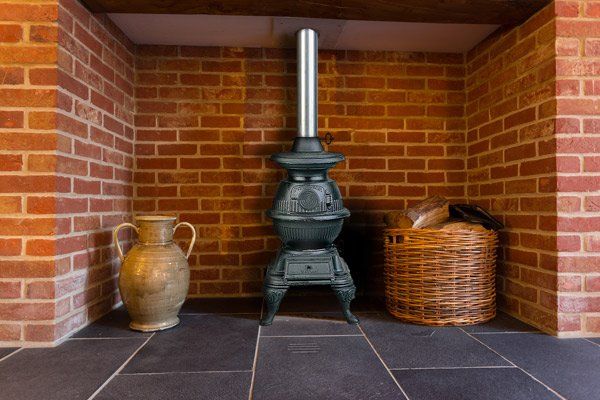 fire pot in front of brick wall