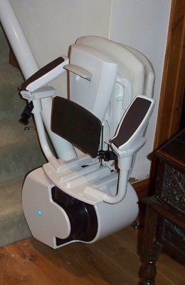 Reconditioned Curved Stairlift at the bottom of the stairs