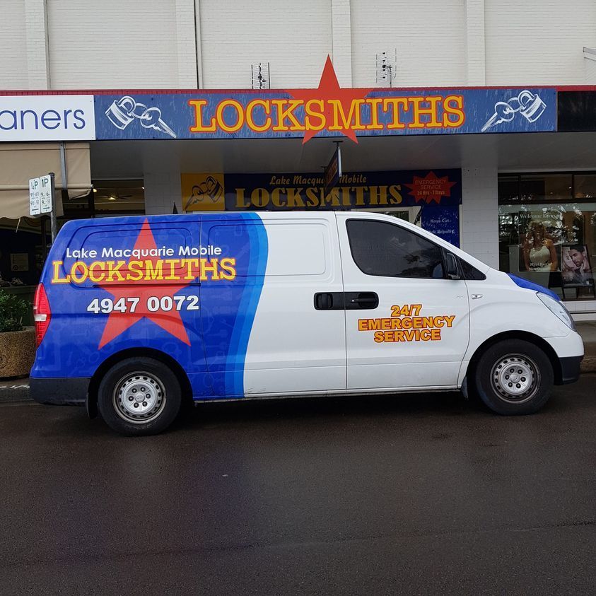White Locksmith Van Parked Outside Locksmith Shop
