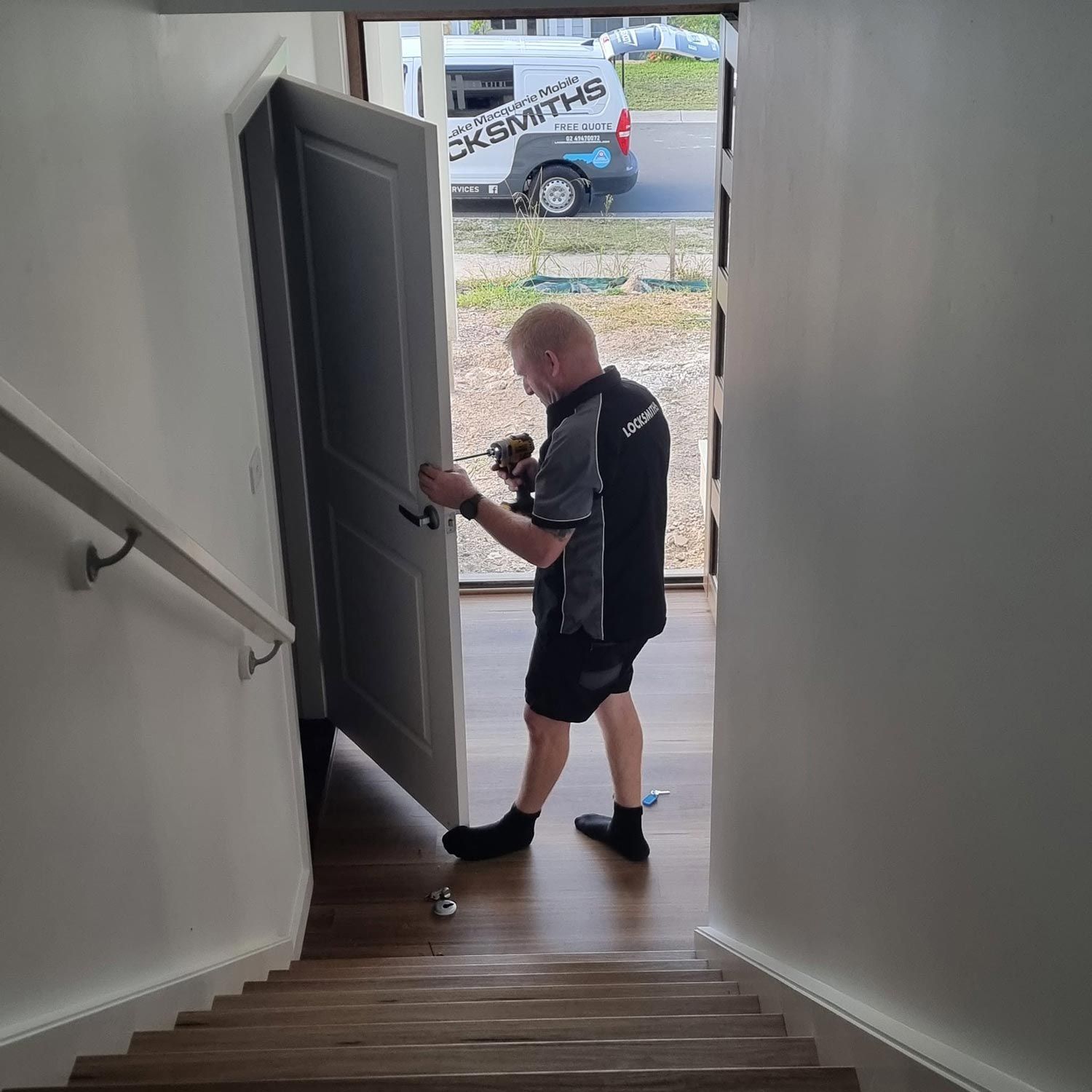Locksmith In Belmont Working On A Door