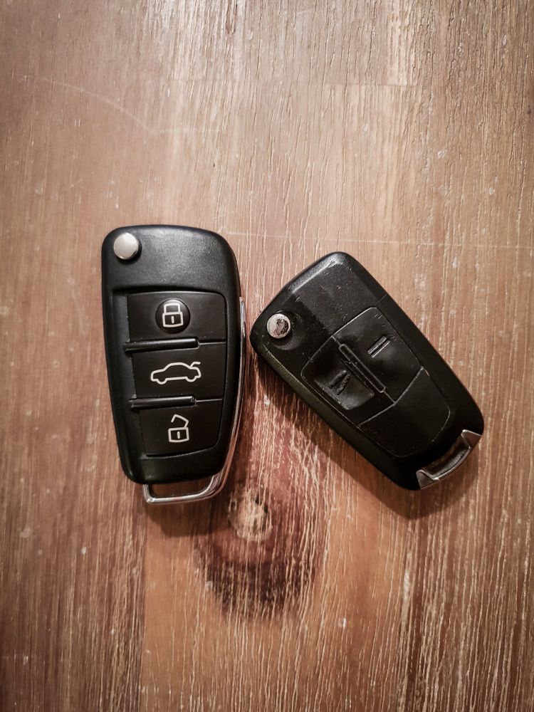 Two Car Remotes on A Wooden Table