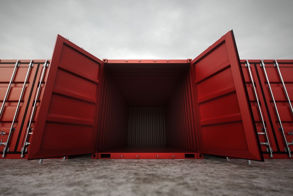 Open Red Shipping Container, Empty Interior, Doors Ajar, Overcast Sky — Johnny Farming Company In Ooralea, QLD