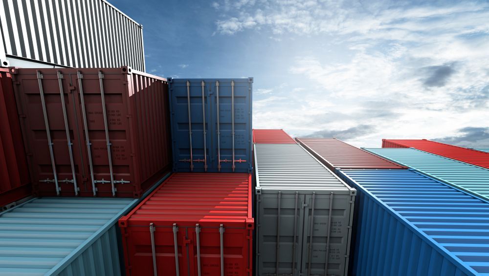 Colourful Stacked Shipping Containers Against a Cloudy Sky — Johnny Farming Company In Ooralea, QLD