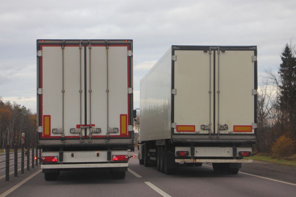 Two White Semi-truck Trailers on a Road, Back View — Johnny Farming Company In Ooralea, QLD