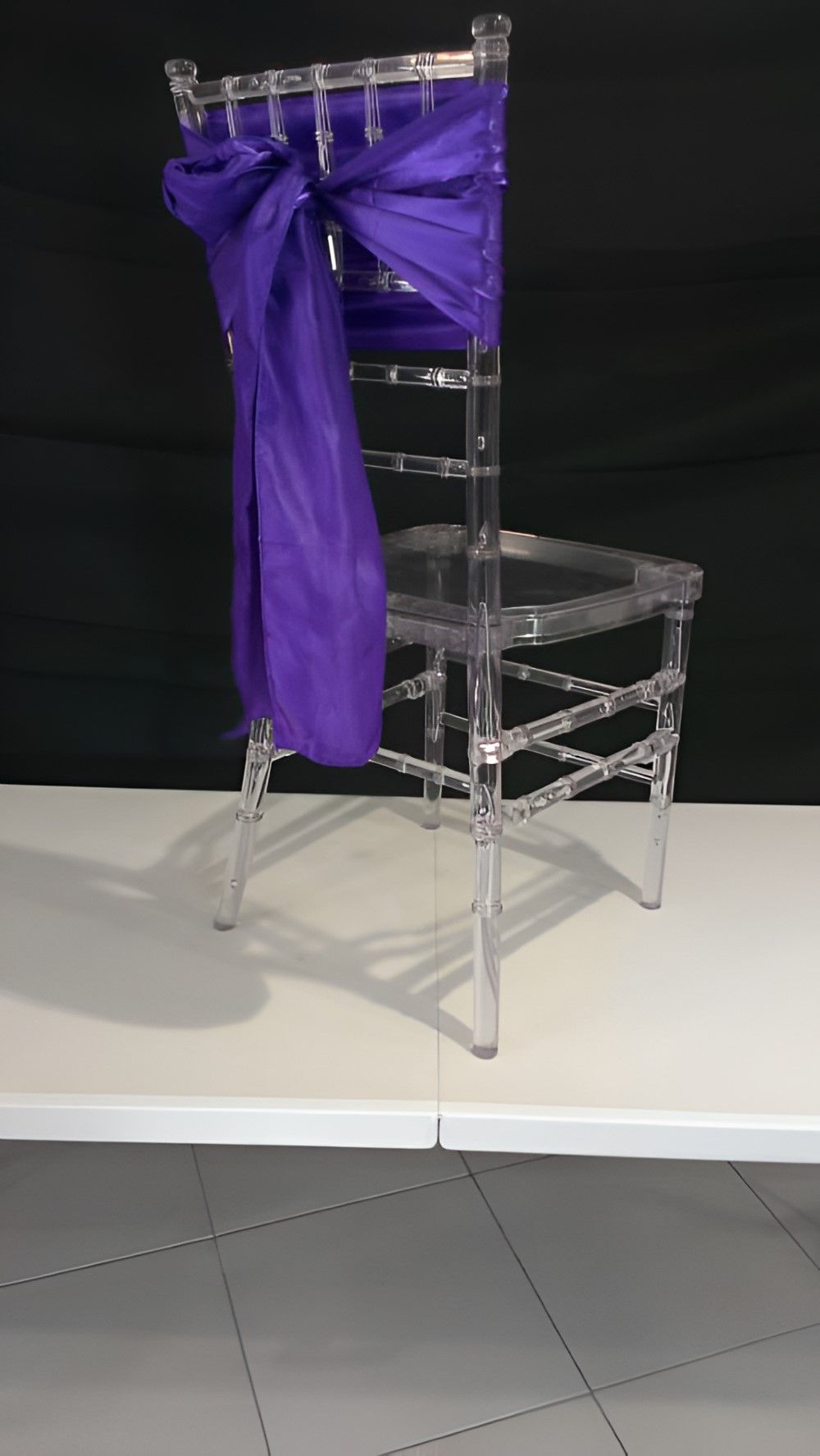 A Clear Chair With A Purple Bow On The Back Is Sitting On A White Table — Johnny Farming Company In Ooralea, QLD