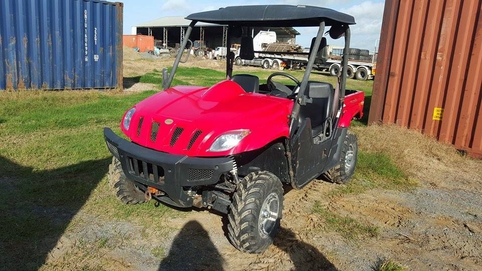 Red Utility Vehicle With a Black Roof, in a Grassy Area With Shipping Containers — Johnny Farming Company In Ooralea, QLD