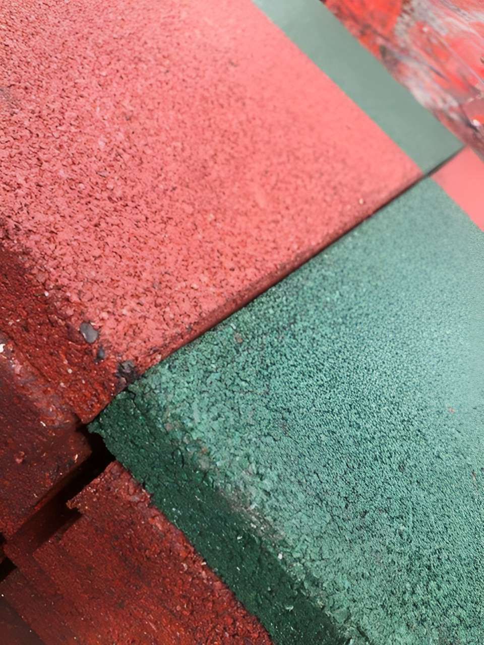 A Close Up Of A Red And Green Rubber Tile — Johnny Farming Company In Ooralea, QLD
