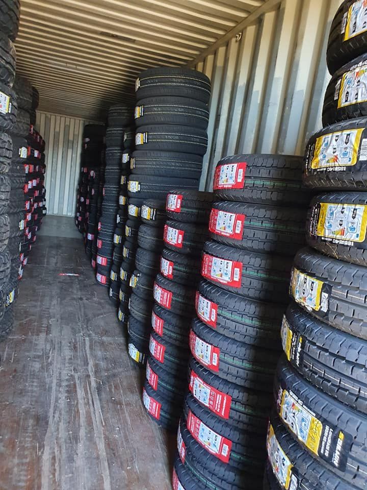 A Warehouse Filled With Lots Of Tires Stacked On Top Of Each Other — Johnny Farming Company In Ooralea, QLD