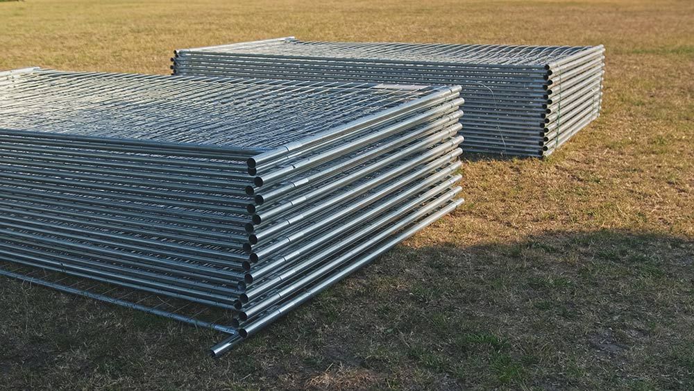 A Bunch of Metal Fences Are Stacked on Top of Each Other in a Field — Johnny Farming Company In Ooralea, QLD