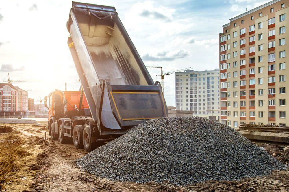 Truck Tipping Dumping Gravel On Road — Landscaping Materials In Robertson, NSW