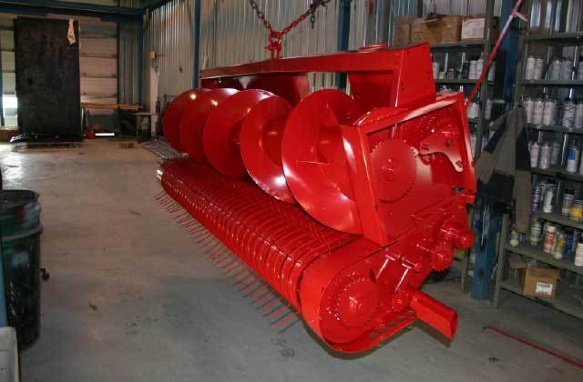 Une machine rouge est suspendue à une chaîne dans un garage