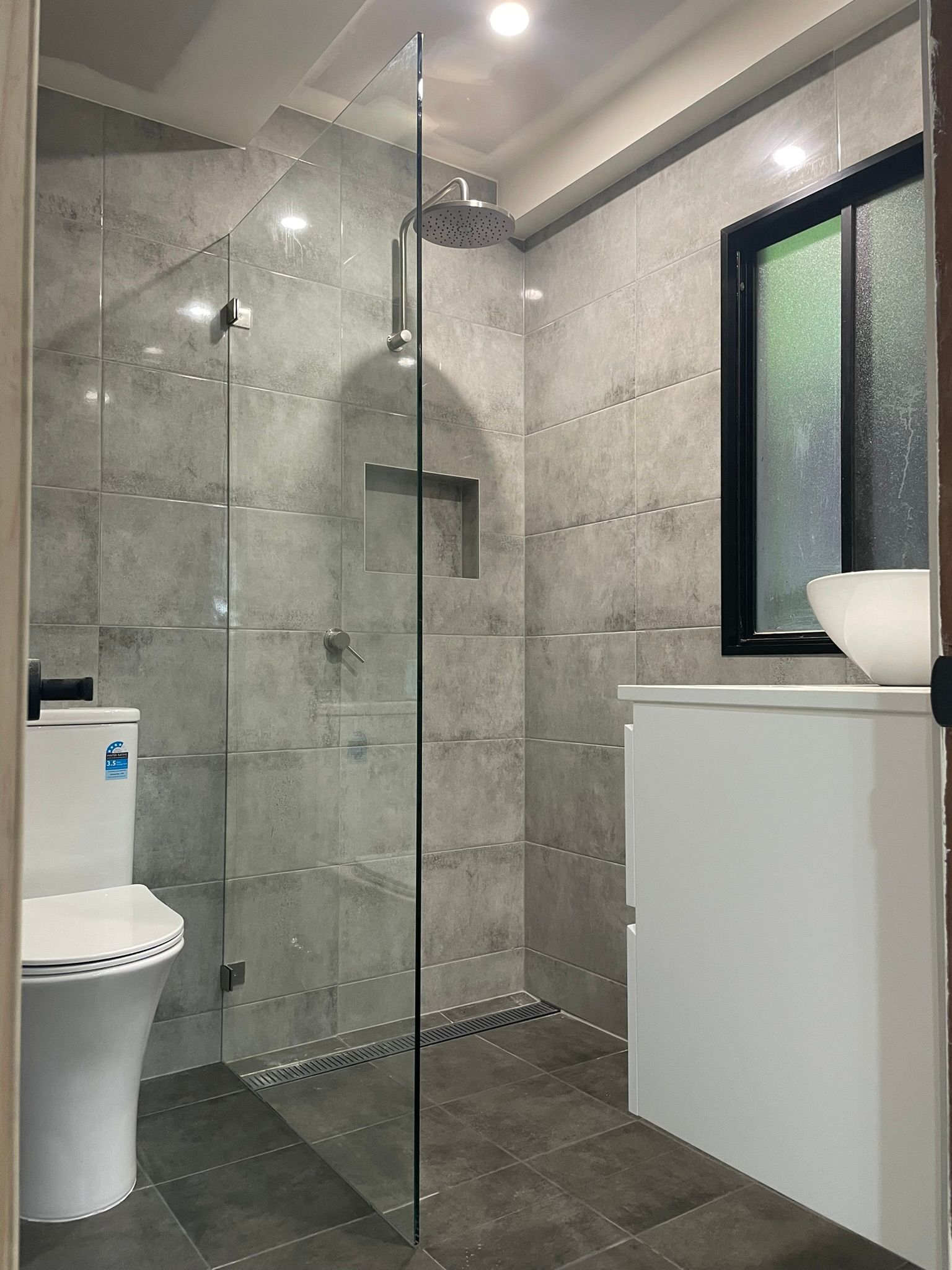 A Kitchen with White Cabinets and A Black Stove Top — Tradewind Building Maintenance in Woonona,NSW