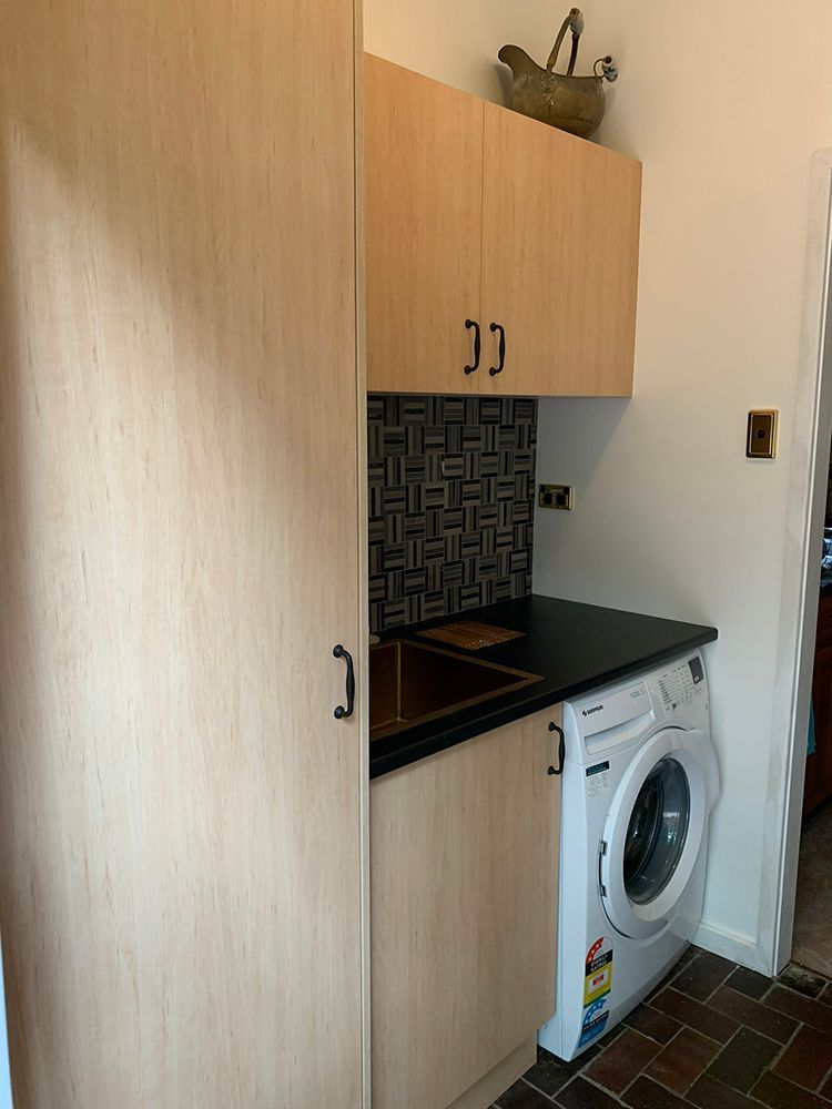 A Laundry Room with A Washing Machine and A Sink — Tradewind Building Maintenance in Wollongong,NSW