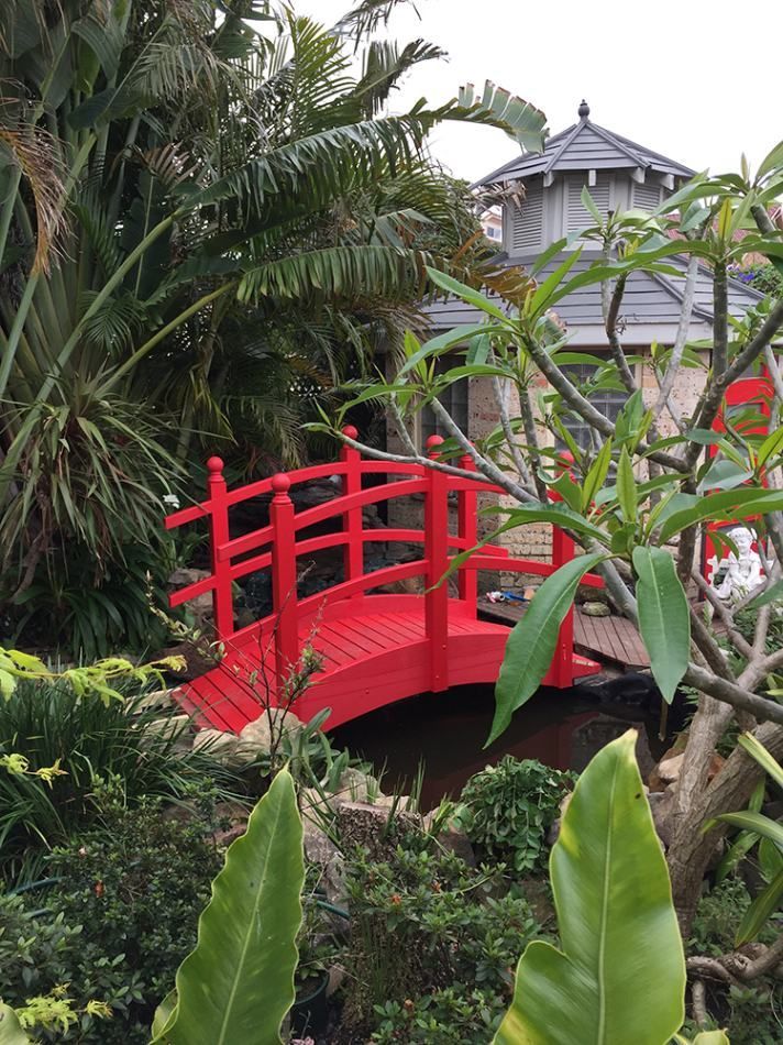 A Red Bridge Over a Body of Water in A Garden — Tradewind Building Maintenance in Bulli,NSW