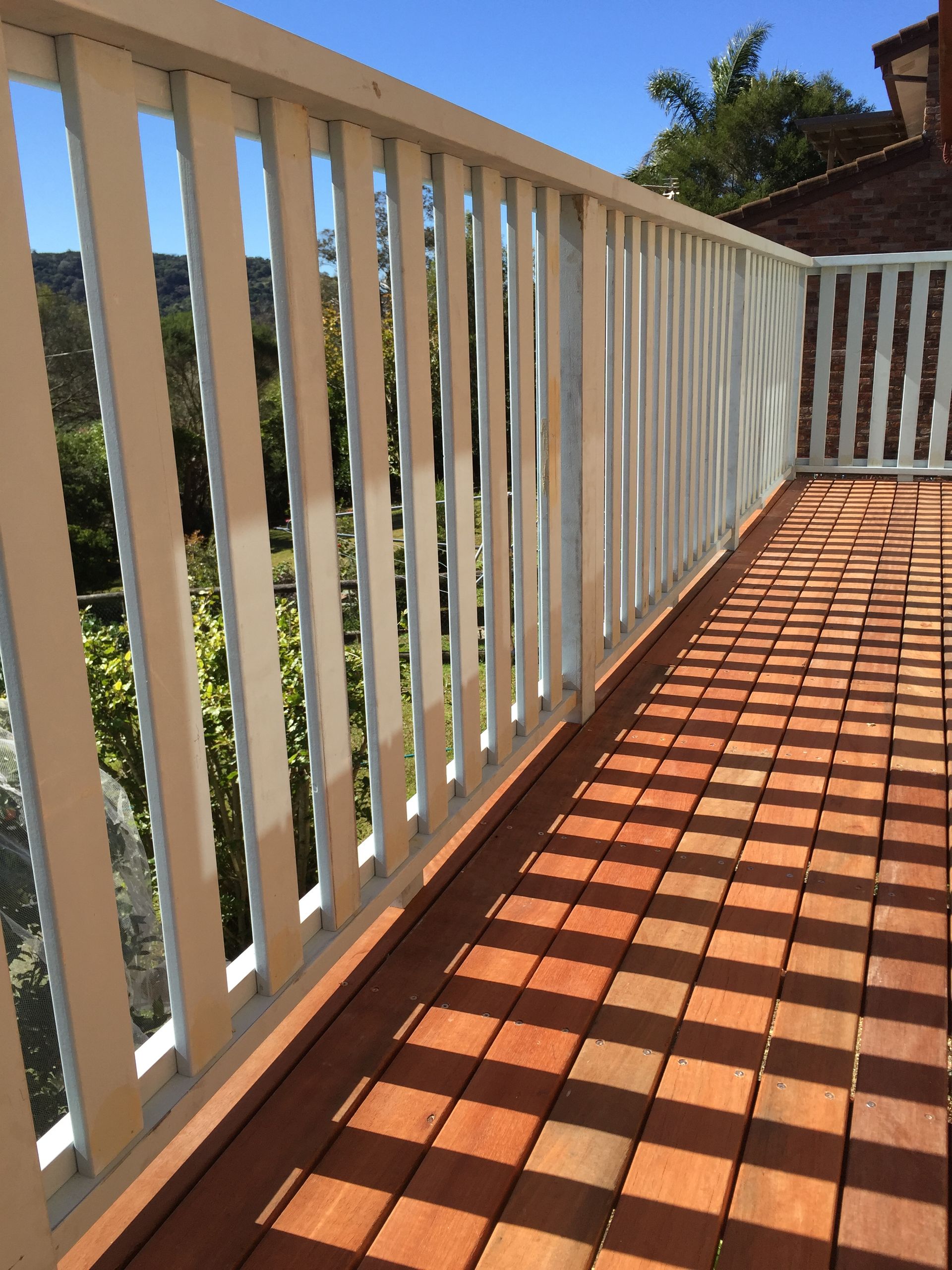 A Set of Wooden Stairs Leading up To a House — Tradewind Building Maintenance in Woonona,NSW