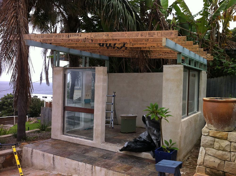 A Shed Is Being Built in The Backyard with A Wooden Roof — Tradewind Building Maintenance in Wollongong,NSW