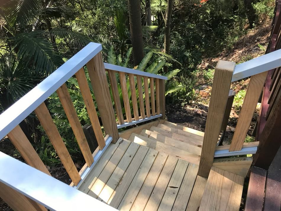 A Wooden Deck with Stairs Leading up To a Forest — Tradewind Building Maintenance in Wollongong,NSW