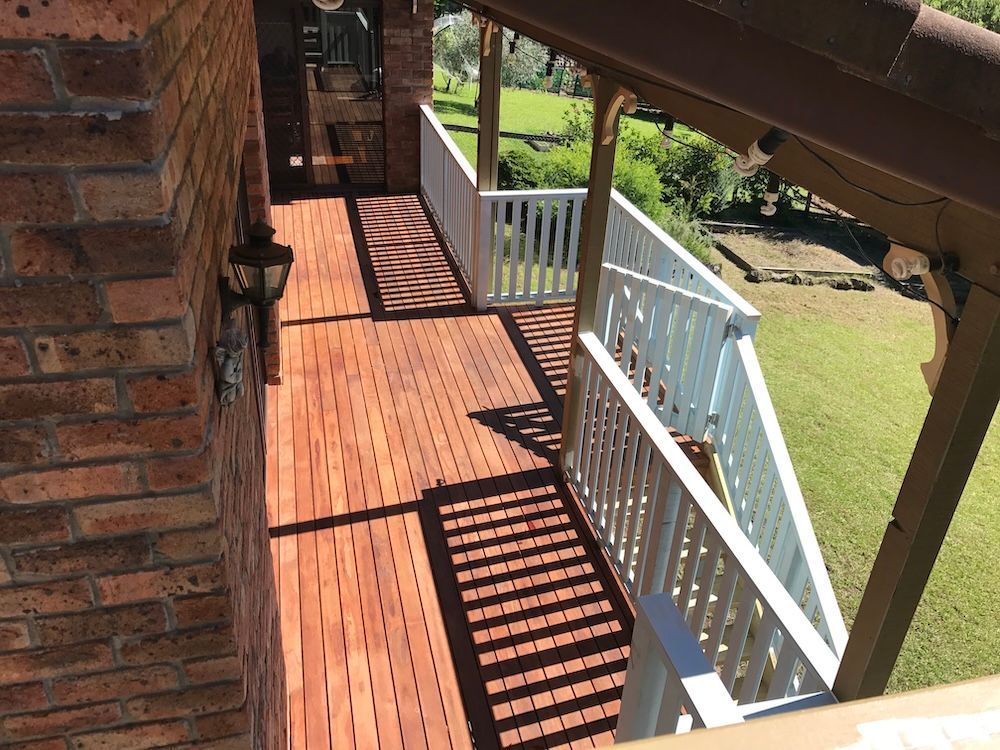 A Wooden Deck with Stairs Leading up To It — Tradewind Building Maintenance in Woonona,NSW