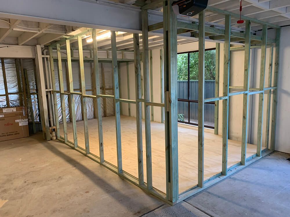 A Room with A Lot of Wooden Frames on The Wall For Renovation — Tradewind Building Maintenance in Woonona,NSW