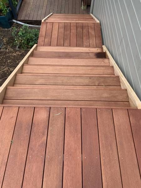A Wooden Deck with Stairs Leading up To It — Tradewind Building Maintenance in Woonona,NSW