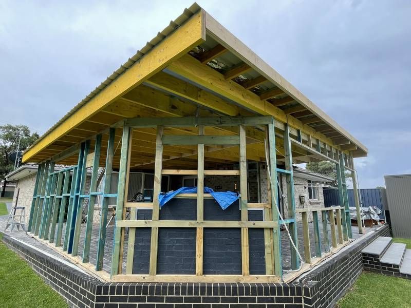 A Large Empty Room with Wooden Floors and Walls — Tradewind Building Maintenance in Woonona,NSW