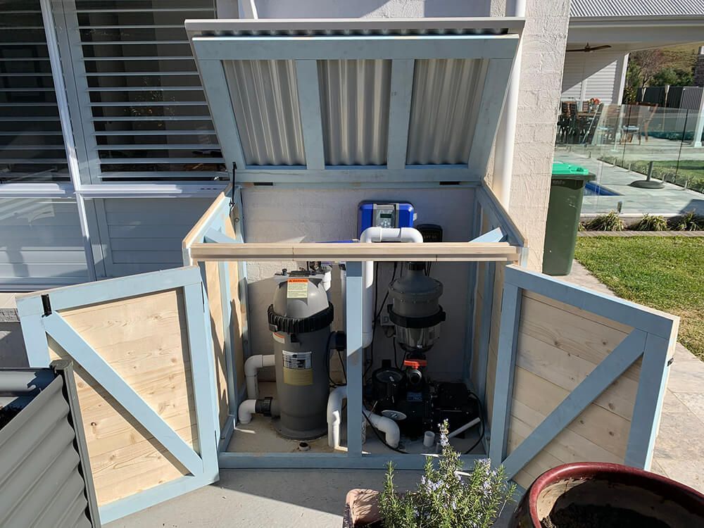 A Wooden Box with A Swimming Pool Filter Pump Inside of It — Tradewind Building Maintenance in Woonona,NSW
